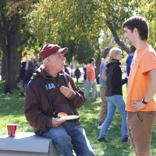 A student speaks to a man during Christ in the City in Denver